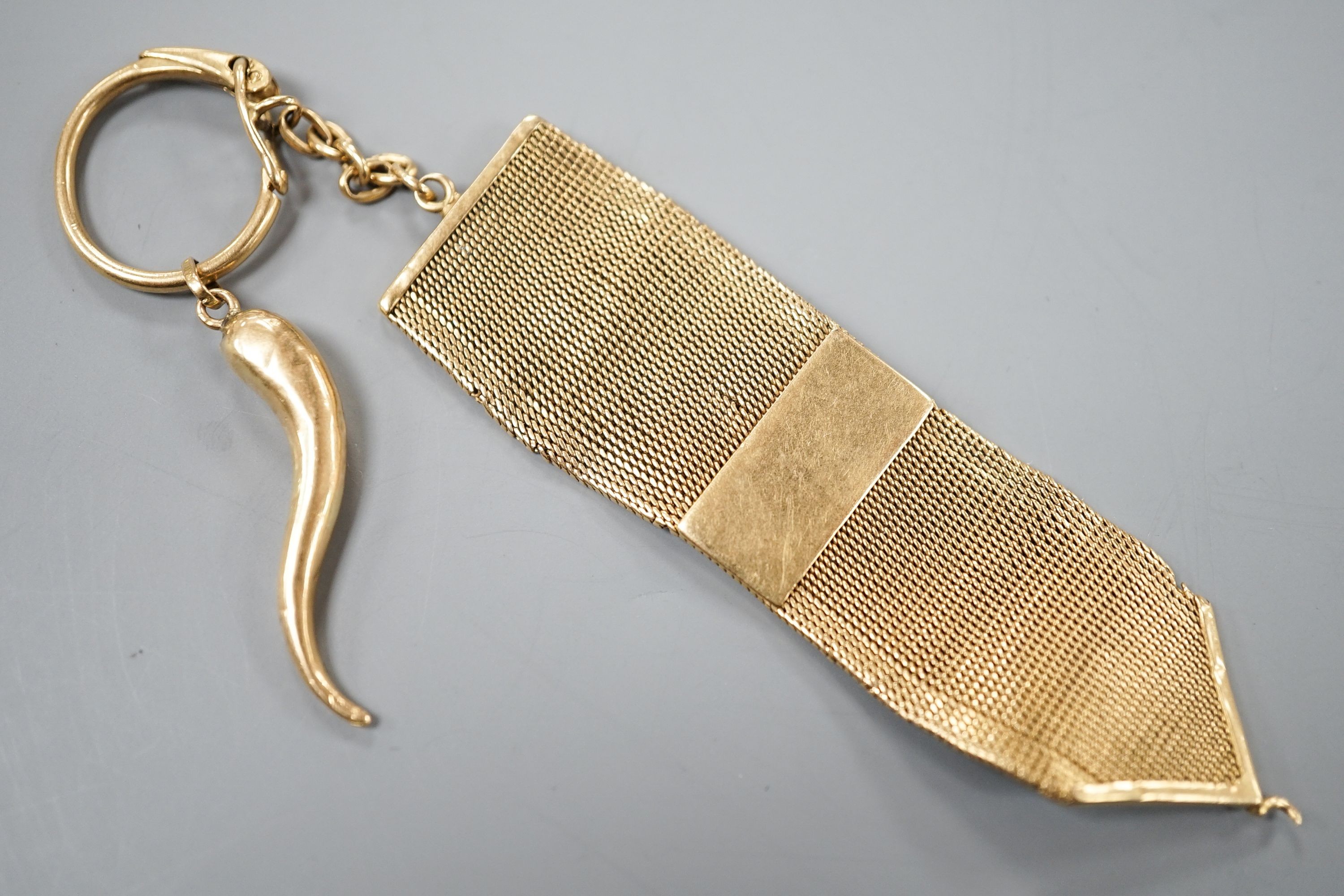An Italian 750 yellow metal mesh link fob, hung with a yellow metal horn of plenty charm, gross 21.5 grams.